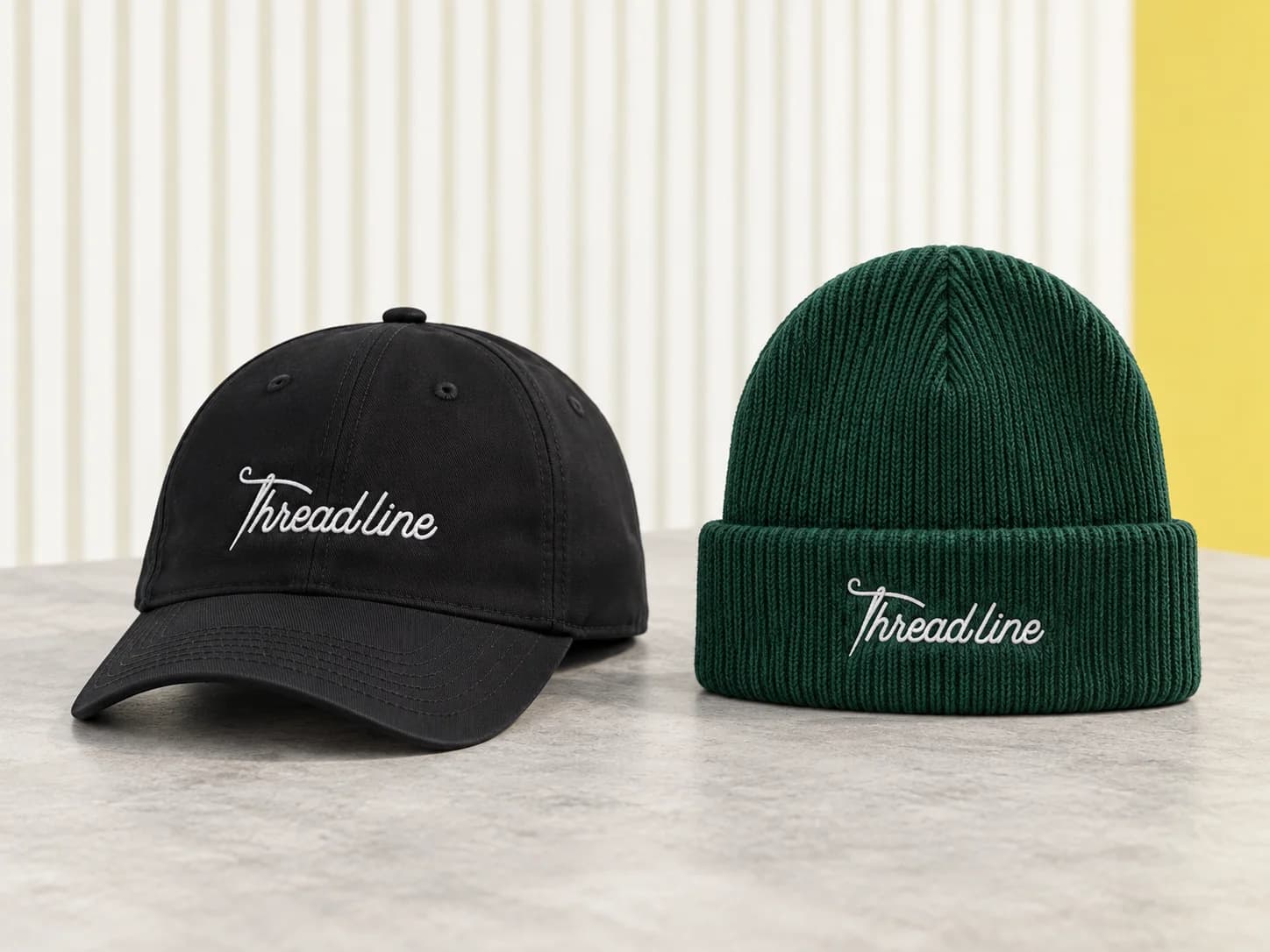 Black baseball cap and forest-green beanie with white Threadline embroidery
