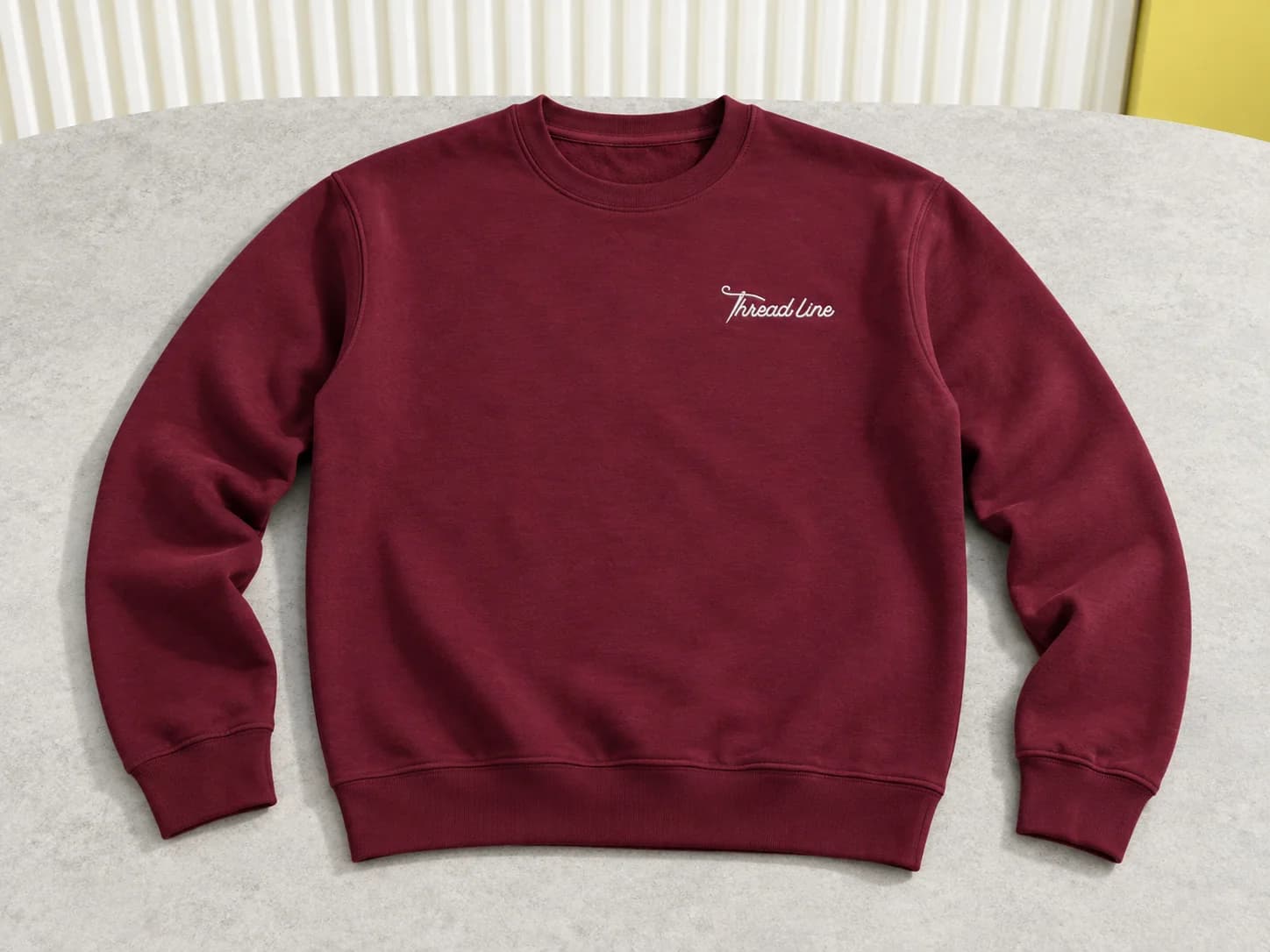 Burgundy crew-neck sweatshirt with white Threadline chest embroidery