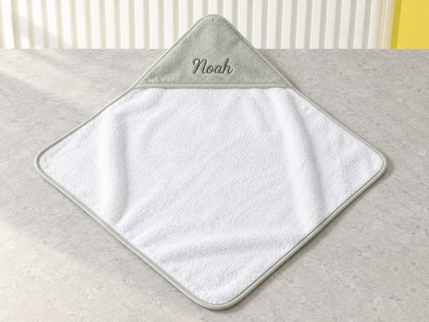 White baby hooded towel with a sage hood embroidered Noah